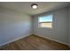 This bedroom features wood-look flooring, a window, and fresh paint at 34141 Tree Lake Dr, Wesley Chapel, FL 33543