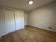 Bedroom features a large closet, wood-look laminate flooring, and neutral paint at 34141 Tree Lake Dr, Wesley Chapel, FL 33543