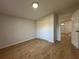 Bedroom featuring a closet, wood-look laminate flooring, and neutral paint at 34141 Tree Lake Dr, Wesley Chapel, FL 33543