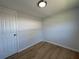 Bedroom featuring light colored walls and wood look flooring at 34141 Tree Lake Dr, Wesley Chapel, FL 33543