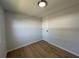 Bedroom featuring wood-look flooring, neutral walls and a flush mount light fixture at 34141 Tree Lake Dr, Wesley Chapel, FL 33543