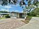 Charming home featuring a screened-in porch and covered carport, perfect for enjoying the outdoors at 34141 Tree Lake Dr, Wesley Chapel, FL 33543