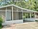 Charming home featuring a screened-in porch and covered carport, perfect for enjoying the outdoors at 34141 Tree Lake Dr, Wesley Chapel, FL 33543