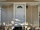 This is a front door with off-white siding and brick embellishments at 34141 Tree Lake Dr, Wesley Chapel, FL 33543