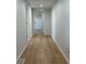 Bright hallway featuring wood-look flooring, fresh paint and modern recessed lighting at 34141 Tree Lake Dr, Wesley Chapel, FL 33543