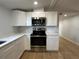 Bright kitchen features white cabinets, stainless steel appliances, and light countertops at 34141 Tree Lake Dr, Wesley Chapel, FL 33543
