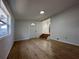 Another view of the living room with neutral colored walls and hardwood flooring at 34141 Tree Lake Dr, Wesley Chapel, FL 33543