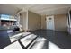 Enclosed porch area featuring tan siding and a durable, gray painted concrete floor at 34141 Tree Lake Dr, Wesley Chapel, FL 33543
