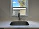 The kitchen sink has stainless fixtures and a window to the outside at 34141 Tree Lake Dr, Wesley Chapel, FL 33543