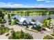 Aerial view of the community clubhouse, with a beautiful lake and green spaces in the background at 4194 Bexley Village Dr, Land O Lakes, FL 34638
