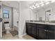 Bathroom with dual sink vanity, granite counters, and a shower and bath combo at 4194 Bexley Village Dr, Land O Lakes, FL 34638