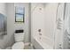 Bright bathroom with shower/tub combo and white tile surround at 4194 Bexley Village Dr, Land O Lakes, FL 34638