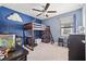 bedroom with wooden bunk bed, ceiling fan, carpeted floors and whimsical decor at 4194 Bexley Village Dr, Land O Lakes, FL 34638