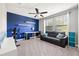 Bonus room with blue accent wall, ceiling fan, comfortable seating, and lots of light at 4194 Bexley Village Dr, Land O Lakes, FL 34638