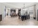 Open-concept dining area featuring a dark wood table and chairs, seamlessly connected to a modern kitchen at 4194 Bexley Village Dr, Land O Lakes, FL 34638