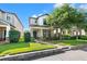 Charming two-story home featuring a covered porch, well-manicured landscaping, and a brick pathway at 4194 Bexley Village Dr, Land O Lakes, FL 34638