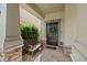 Charming front entrance with a dark door, brick accents, and a cozy bench for welcoming guests at 4194 Bexley Village Dr, Land O Lakes, FL 34638