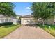 View of the garage and brick driveway framed by lush landscaping, offering great curb appeal at 4194 Bexley Village Dr, Land O Lakes, FL 34638