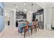 A kitchen featuring stainless steel appliances, a blue island with granite countertop, and barstool seating at 4194 Bexley Village Dr, Land O Lakes, FL 34638
