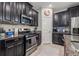 Close up of kitchen featuring stainless steel appliances, granite counters, and dark cabinetry at 4194 Bexley Village Dr, Land O Lakes, FL 34638