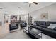 Spacious living room with modern furnishings, including a black sofa and chairs, open to the kitchen at 4194 Bexley Village Dr, Land O Lakes, FL 34638