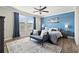 Comfortable main bedroom with a blue accent wall, ceiling fan and lots of natural light at 4194 Bexley Village Dr, Land O Lakes, FL 34638