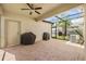 Covered patio with brick pavers, ceiling fan and outdoor cooking grills at 4194 Bexley Village Dr, Land O Lakes, FL 34638