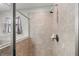 Bright shower featuring glass enclosure and tile surround, with updated shower head at 4194 Bexley Village Dr, Land O Lakes, FL 34638