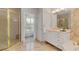 Elegant bathroom with a gold framed shower, double vanity, and natural light from the window at 4301 W Swann Ave, Tampa, FL 33609