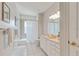 Clean bathroom with white tile, neutral walls, shower/tub combo, and a single sink vanity at 4301 W Swann Ave, Tampa, FL 33609