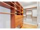 Walk-in closet features custom wood shelving and drawers for ample storage space at 4301 W Swann Ave, Tampa, FL 33609