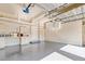 Bright garage with epoxy flooring, built-in storage, a workspace, and overhead storage racks at 4301 W Swann Ave, Tampa, FL 33609