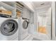 Laundry room with new front load washer and dryer, built-in shelves, and access to more living space at 4301 W Swann Ave, Tampa, FL 33609