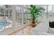 Living room features large windows, French doors to pool, and plant accent at 4301 W Swann Ave, Tampa, FL 33609