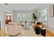 Bright living room featuring hardwood floors, neutral furniture, large windows, and wainscoting at 4301 W Swann Ave, Tampa, FL 33609