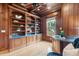 Bright home office featuring custom built-ins, wood paneling and natural light at 4301 W Swann Ave, Tampa, FL 33609
