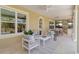 Outdoor living space with seating, outdoor kitchen, and lush landscaping at 4301 W Swann Ave, Tampa, FL 33609
