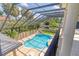 Aerial view of a private, screened-in pool with lush tropical landscaping, perfect for relaxation at 4301 W Swann Ave, Tampa, FL 33609