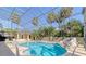 Enclosed pool area with cabana and tropical landscaping at 4301 W Swann Ave, Tampa, FL 33609