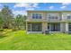 Backyard featuring lush green lawn, patio, and exterior building at 4516 Barnstead Dr, Riverview, FL 33578