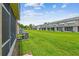 This home features a long, lush green lawn space in the backyard with screened in patios at 4516 Barnstead Dr, Riverview, FL 33578