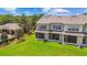 Spacious townhome backyard with lush green grass and screened in lanai at 4516 Barnstead Dr, Riverview, FL 33578