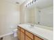 Bathroom featuring a tiled floor, vanity, mirror, lighting, toilet and shower at 4516 Barnstead Dr, Riverview, FL 33578
