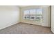 Bedroom with neutral carpet and a window overlooking the neighborhood at 4516 Barnstead Dr, Riverview, FL 33578