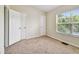 Well-lit bedroom with a double door closet and a large window at 4516 Barnstead Dr, Riverview, FL 33578