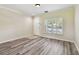 Bright, empty living space featuring stylish flooring and large windows for natural light at 4516 Barnstead Dr, Riverview, FL 33578