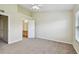 Spacious main bedroom with neutral carpeting, and a view into the attached bathroom at 4516 Barnstead Dr, Riverview, FL 33578