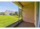 Screened-in patio with a lush green lawn view and exterior building at 4516 Barnstead Dr, Riverview, FL 33578