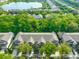 Aerial view of townhomes with lush landscaping and a beautiful lake in the background at 4916 Chatham Gate Dr, Riverview, FL 33578
