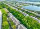 Wide aerial view of townhomes, lakes, and green spaces showcases the neighborhood's layout and natural beauty at 4916 Chatham Gate Dr, Riverview, FL 33578
